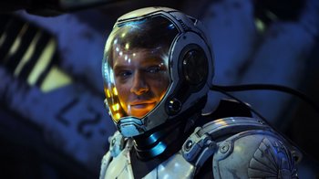 Movie still from “Pacific Rim” (2013), directed by Guillermo del Toro – A man in a space suit is wearing a helmet; Close Up shot, Over the shoulder angle