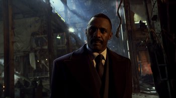 Movie still from “Pacific Rim” (2013), directed by Guillermo del Toro – A man wearing a suit and tie standing in an industrial setting; Close Up shot, Low angle
