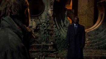 Movie still from “Pacific Rim” (2013), directed by Guillermo del Toro – A man standing in front of an old building; Medium shot, Over the shoulder angle