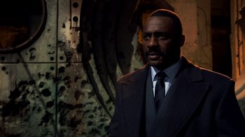 Movie still from “Pacific Rim” (2013), directed by Guillermo del Toro – A man wearing a suit and tie standing in front of a wall; Close Up shot, High angle