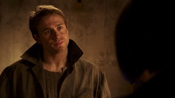 Movie still from “Pacific Rim” (2013), directed by Guillermo del Toro – A man in a brown jacket looking at the camera; Close Up shot, Over the shoulder angle