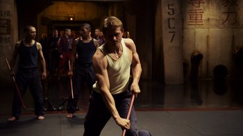 Movie still from “Pacific Rim” (2013), directed by Guillermo del Toro – A man holding a stick in his hands; Medium shot, Low angle