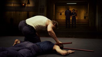Movie still from “Pacific Rim” (2013), directed by Guillermo del Toro – Two men are wrestling in a wrestling ring; Wide shot, High angle