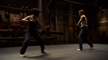 Movie still from “Pacific Rim” (2013), directed by Guillermo del Toro – A couple of people that are in a room; Wide shot, Over the shoulder angle