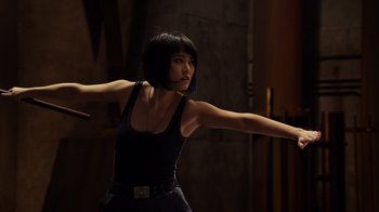 Movie still from “Pacific Rim” (2013), directed by Guillermo del Toro – A woman in a black tank top and black pants; Medium shot, Low angle