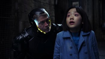 Movie still from “Pacific Rim” (2013), directed by Guillermo del Toro – A man and a girl in a room; Medium shot, Over the shoulder angle
