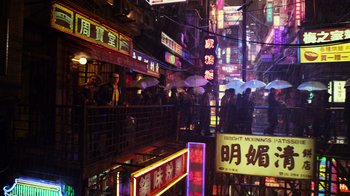 Movie still from “Pacific Rim” (2013), directed by Guillermo del Toro – A group of people standing in a city at night with neon lights; Extreme Wide shot, High angle