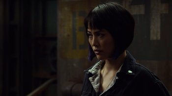 Movie still from “Pacific Rim” (2013), directed by Guillermo del Toro – A woman with short black hair wearing a black jacket; Close Up shot, Over the shoulder angle