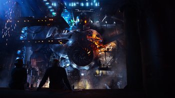 Movie still from “Pacific Rim” (2013), directed by Guillermo del Toro – A man sitting in front of a large screen; Extreme Wide shot, Low angle