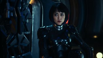 Movie still from “Pacific Rim” (2013), directed by Guillermo del Toro – A woman in a black and silver outfit; Close Up shot, Over the shoulder angle