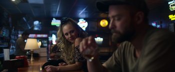 Movie still from “Palmer” (2021), directed by Fisher Stevens – A woman sitting next to a man holding a drink; Close Up shot, Over the shoulder angle