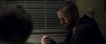 Movie still from “Palmer” (2021), directed by Fisher Stevens – A man with a goatee and a beard is looking at the camera; Close Up shot, Over the shoulder angle