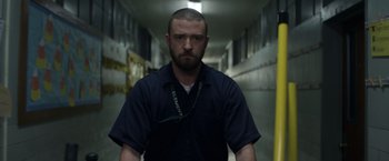 Movie still from “Palmer” (2021), directed by Fisher Stevens – A man with a beard is standing in a hallway; Close Up shot, Low angle