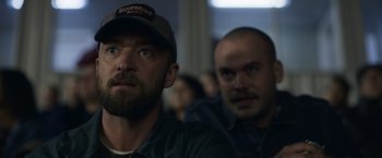 Movie still from “Palmer” (2021), directed by Fisher Stevens – A man with a beard wearing a hat; Close Up shot, Over the shoulder angle