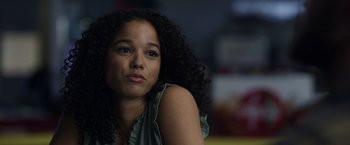 Movie still from “Palmer” (2021), directed by Fisher Stevens – A person with curly black hair; Close Up shot, Low angle