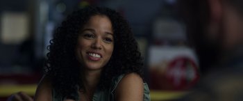 Movie still from “Palmer” (2021), directed by Fisher Stevens – A person with curly black hair; Close Up shot, Over the shoulder angle