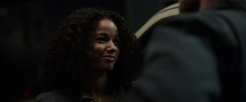 Movie still from “Palmer” (2021), directed by Fisher Stevens – A person with curly black hair; Close Up shot, Over the shoulder angle