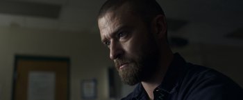 Movie still from “Palmer” (2021), directed by Fisher Stevens – A person with a beard looking at the camera; Close Up shot, Low angle