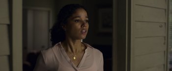 Movie still from “Palmer” (2021), directed by Fisher Stevens – A woman in a pink shirt is looking to her left; Close Up shot, Low angle