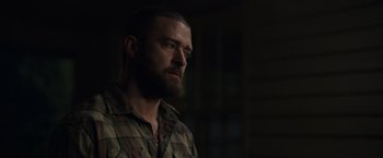 Movie still from “Palmer” (2021), directed by Fisher Stevens – A person with a beard looking to his left; Close Up shot, Over the shoulder angle