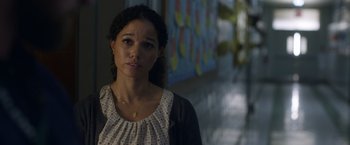 Movie still from “Palmer” (2021), directed by Fisher Stevens – A woman standing next to a wall in a room; Close Up shot, Over the shoulder angle