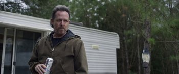Movie still from “Palmer” (2021), directed by Fisher Stevens – A person standing in front of a trailer; Close Up shot, Over the shoulder angle