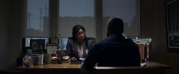 Movie still from “Palmer” (2021), directed by Fisher Stevens – Two people sitting at a table talking to each other; Medium shot, Over the shoulder angle