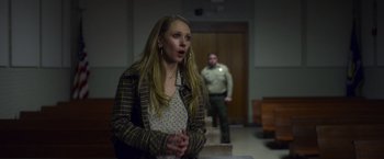 Movie still from “Palmer” (2021), directed by Fisher Stevens – A woman standing next to a man in a room; Medium shot, Over the shoulder angle