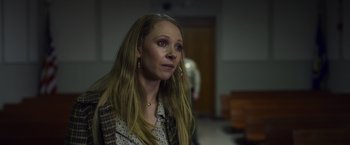 Movie still from “Palmer” (2021), directed by Fisher Stevens – A woman with long blonde hair wearing a plaid jacket; Close Up shot, Over the shoulder angle