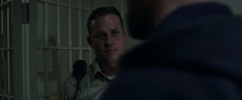 Movie still from “Palmer” (2021), directed by Fisher Stevens – A man in a jail cell looking at the camera; Close Up shot, Over the shoulder angle
