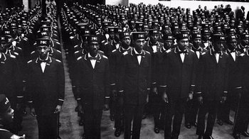 Movie still from “Atlanta” (2016), created by Donald Glover – A black and white photo of a group of men in uniforms; Wide shot, High angle