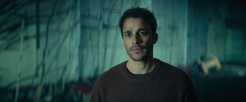 A person wearing a brown sweater