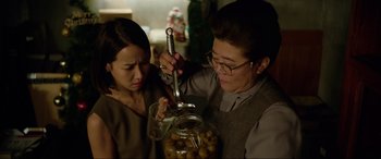 Movie still from “Parasite” (2019), directed by Bong Joon Ho – A woman and a woman holding a glass jar with olives inside of it; Close Up shot, Over the shoulder angle