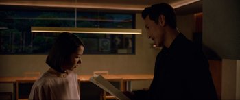 Movie still from “Parasite” (2019), directed by Bong Joon Ho – A man and a woman looking at a piece of paper; Medium shot, Over the shoulder angle