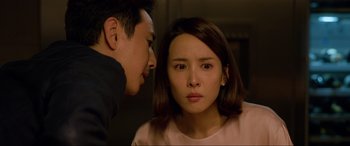 Movie still from “Parasite” (2019), directed by Bong Joon Ho – A man and a woman staring at each other; Close Up shot, Over the shoulder angle
