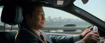 Movie still from “Parasite” (2019), directed by Bong Joon Ho – An older man sitting in the driver's seat of a car; Close Up shot, Over the shoulder angle