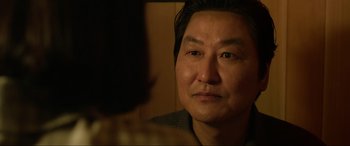 Movie still from “Parasite” (2019), directed by Bong Joon Ho – A person looking into a mirror; Close Up shot, Over the shoulder angle