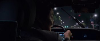 Movie still from “Parasite” (2019), directed by Bong Joon Ho – An older man driving a car at night; Close Up shot, Over the shoulder angle