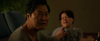 Movie still from “Parasite” (2019), directed by Bong Joon Ho – An older man and a younger woman in a dark room; Close Up shot, Over the shoulder angle