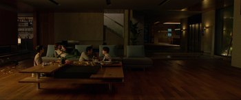 Movie still from “Parasite” (2019), directed by Bong Joon Ho – A man and a boy sitting at a dining table; Wide shot, High angle