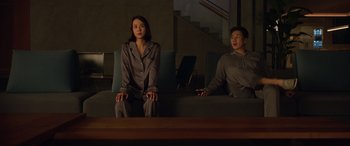 Movie still from “Parasite” (2019), directed by Bong Joon Ho – A man and a woman sitting on a couch; Medium shot, High angle
