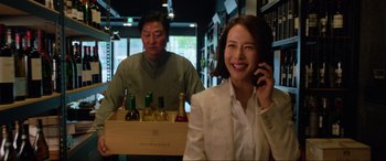Movie still from “Parasite” (2019), directed by Bong Joon Ho – A man and a woman are talking on the phone; Medium shot, Over the shoulder angle