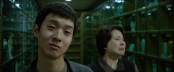 Movie still from “Parasite” (2019), directed by Bong Joon Ho – Two young people standing next to each other in a room; Close Up shot, Low angle
