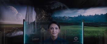 Movie still from “Passengers” (2016), directed by Morten Tyldum – A woman in front of an image of the earth; Close Up shot, Over the shoulder angle