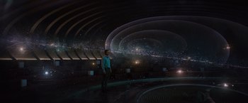 Movie still from “Passengers” (2016), directed by Morten Tyldum – A man standing in front of an empty stage; Extreme Wide shot, High angle