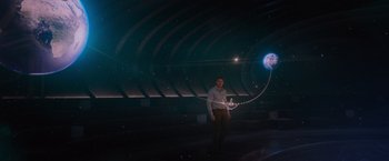 Movie still from “Passengers” (2016), directed by Morten Tyldum – A man holding a kite in a dark room; Extreme Wide shot, Low angle