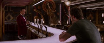 Movie still from “Passengers” (2016), directed by Morten Tyldum – A man sitting at the bar of a restaurant; Wide shot, Over the shoulder angle