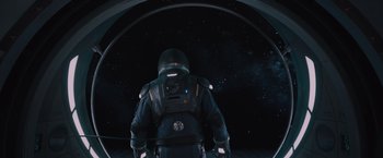 Movie still from “Passengers” (2016), directed by Morten Tyldum – A person in a spacesuit looking at the stars; Wide shot, Overhead angle