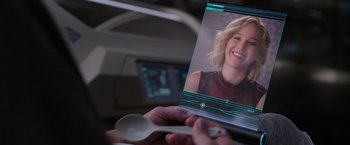 Movie still from “Passengers” (2016), directed by Morten Tyldum – A person holding a remote control in their hand; Extreme Close Up shot, Over the shoulder angle