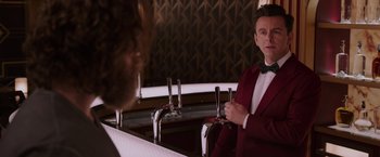 Movie still from “Passengers” (2016), directed by Morten Tyldum – A man standing in front of a mirror in a bar; Medium shot, Over the shoulder angle